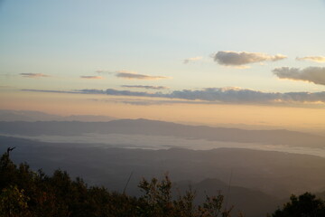 Mountain Range Under Clear Blue Sky with Soft Clouds