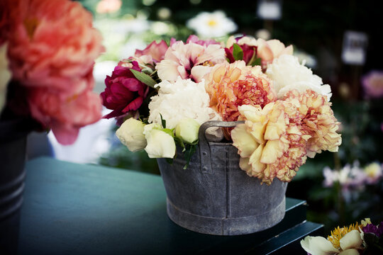 Detail of multi colored peonies in enamel can