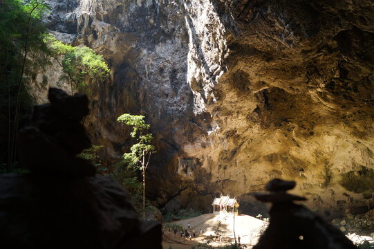 The sun illuminates the temple standing in a cave.