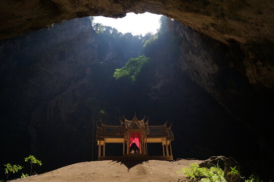 Sunlight falls on the golden temple in the cave