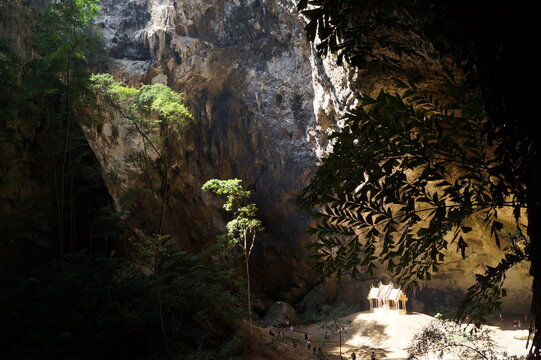 the sun illuminates the golden temple through the opening in the cave.