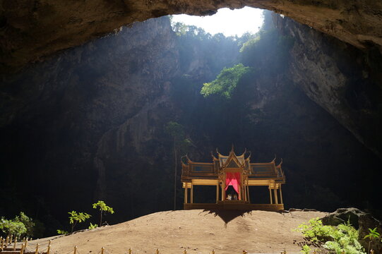 Sunlight falls on the golden temple in the cave.