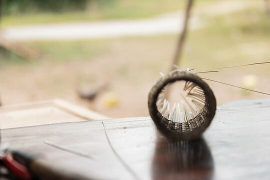 Handwoven bamboo fish trap on rustic table