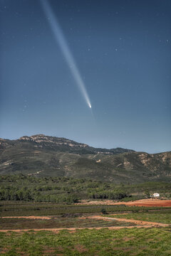 Night Photography of Interstellar Comet Over Mountains