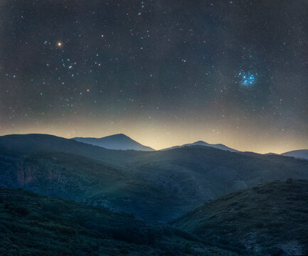 Taurus Constellation Above Hills and Mountains