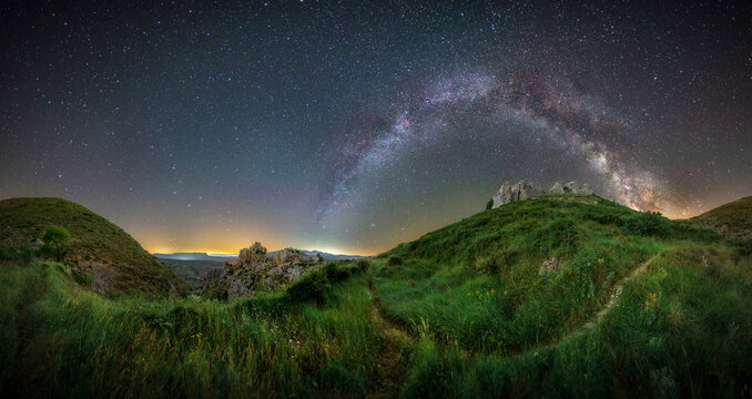 Milky Way Arching Over Benissili Castle and Mountain Landscape