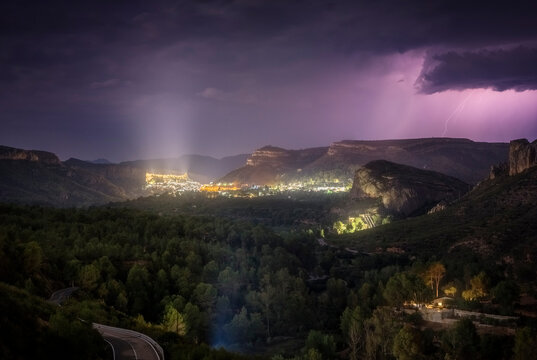 Lightning Storm Over a Mountain Village at Night