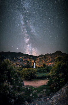 Panoramic View of Starry Sky and Waterfall in the Mountains