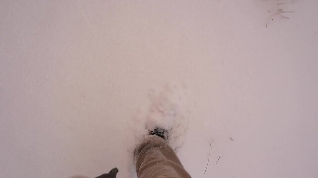 POV of walking through deep snow in Erzurum, Turkey, during active snowfall, boots sinking with each step. Winter adventure highlighting cold weather, survival, and outdoor exploration. For travel.