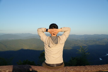 Man Sitting and Enjoying Mountain Landscape at Scenic Viewpoint