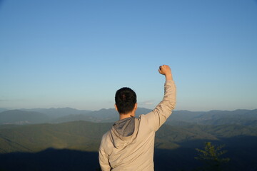 Man Sitting and Enjoying Mountain Landscape at Scenic Viewpoint