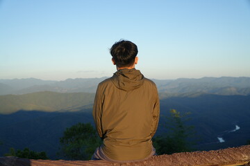 Man Sitting and Enjoying Mountain Landscape at Scenic Viewpoint