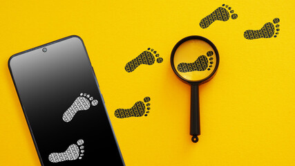 Digital Footprint Tracking Concept - Smartphone with Footprints and Magnifying Glass. Online...
