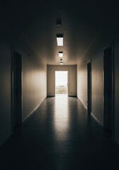 Architectural interior view of a long, empty hallway leading toward an open doorway at the far end, highlighting vanishing point perspective and shadow contrast, architecture, space, shadow