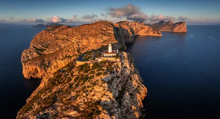 Mallorca, Spain - Aerial panoramic view of the Lighthouse at Cap de Formentor at sunrise with amazing cliffs of the Balearic islands and clouds and blue sky at background © zgphotography