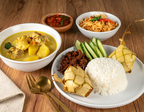 Opor Ayam Coconut Chicken Curry with Ketupat, Rendang, Mentimun, Lebaran Menu, Clean Stock Photo