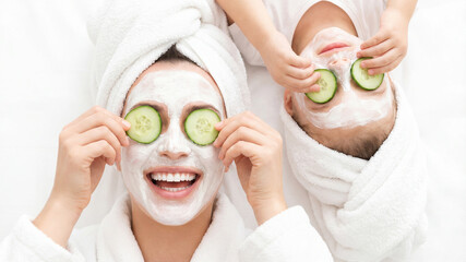Mother and daughter enjoying spa facial mask treatment