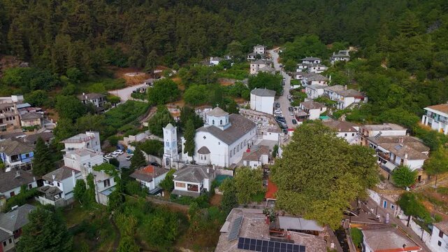 Scenic aerial drone orbit around the whitewashed Church of Panagia in the picturesque mountain village of Panagia, Thasos Island, Eastern Macedonia, Greece.