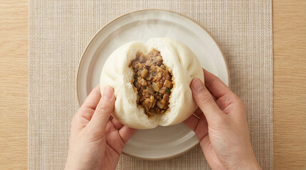 Top View Of Korean Steamed Meat Bun In Hands