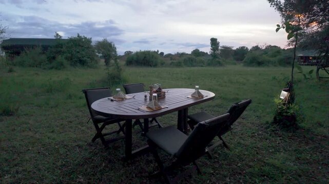 Outdoor dinner table setup in the bush at dusk