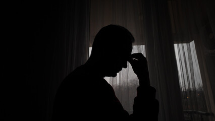 Man with headache, depression, sadness and loneliness at home