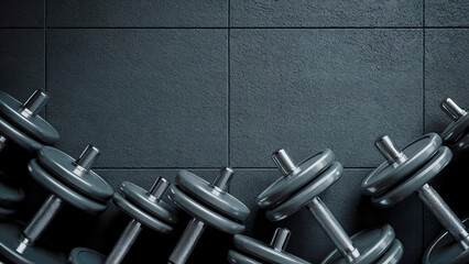 Multiple dumbbells on a dark  textured background. Space for text. 