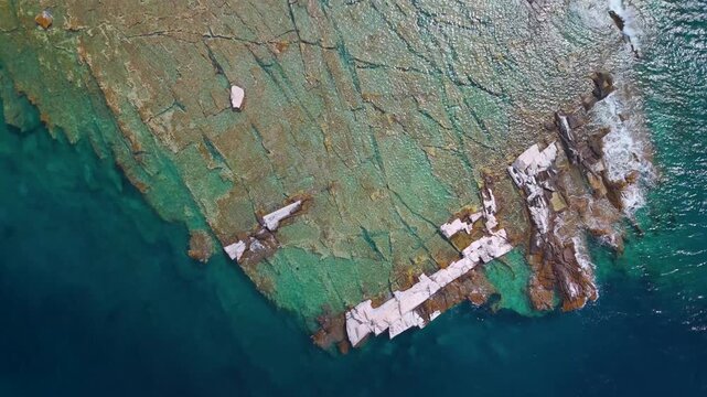 Vertical Top-Down Aerial Drone Shot Over the Ancient Marble Quarries of Alyki Peninsula, Thasos, Greece, Highlighting the Rugged Coastline and Turquoise Aegean Sea.