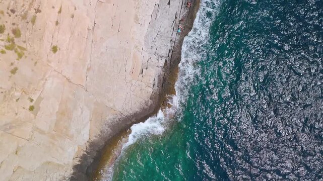 Dynamic Aerial Drone Shot High Above Giola Lagoon (Aphrodite's Tear), the Natural Rock Swimming Pool Carved into the Rugged Coastline of Thasos Island, Greece.