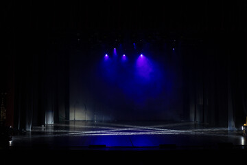 Obraz premium An empty stage of the theater, lit by spotlights and smoke before the performance