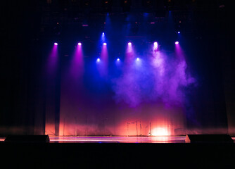Naklejka premium scene, stage light with colored spotlights and smoke