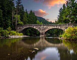 Obraz premium Stone Bridge Arches over Tranquil River at Dusk