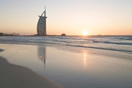 Burj Al Arab reflecting on the beach at sunset in Dubai
