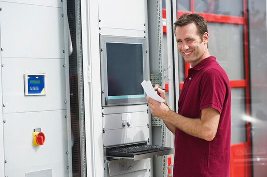 Technician checking control cabinet in photovoltaic facility in Munich