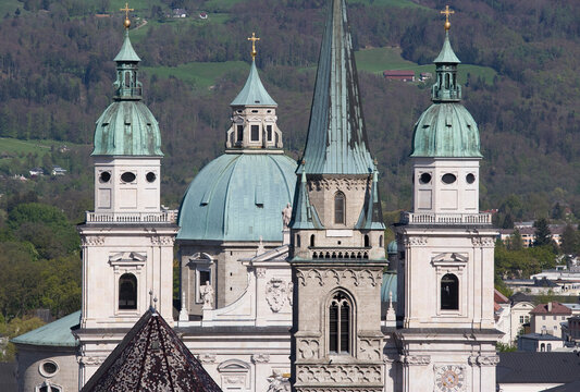 Baroque towers and dome of Salzburg Cathedral with Alps backdrop
