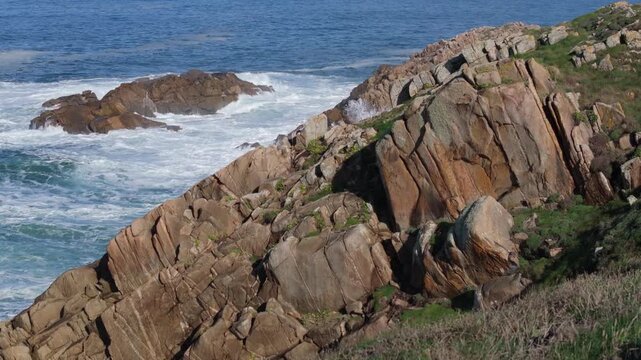 Rocky Sea Cliffs With Crashing Waves At Senda Azul (Paseo Mar&iacute;timo de Arteixo) In Arteixo, A Coru&ntilde;a, Spain. Aerial Sideways Shot