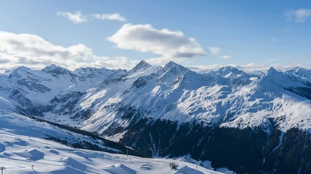 On the Jakobshorn mountain in Davos in winter. You can see the mountain ranges and the ski slopes with the cable cars. Beautiful winter landscape in the Swiss mountains.