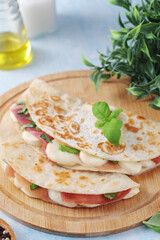Traditional Italian dish Piadina romagnola - flat bread with mozarella and proscuitto	