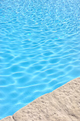 The edge of an outdoor swimming pool.