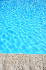 The edge of an outdoor swimming pool.