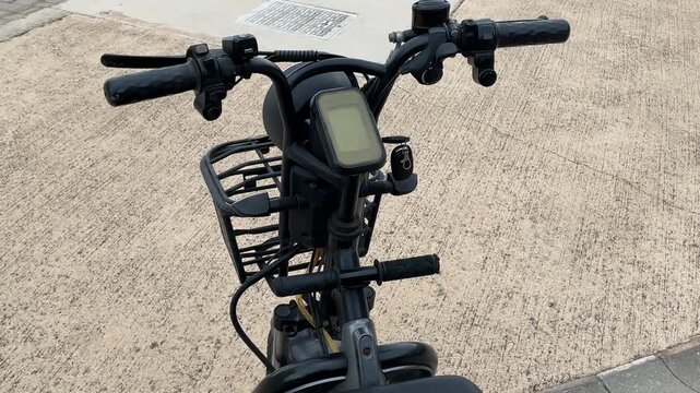 Electric bicycle with riders view of handlebars and road, featuring digital display