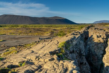 view of the fault line of the rift valley of the Mid-Atlantic Ridge at the Grjotagja Caves near Myvatn Lake in Icleand