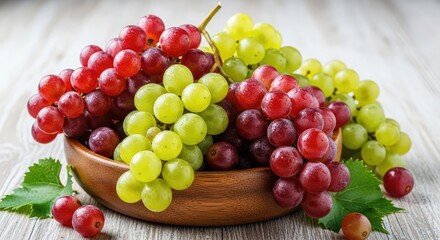 Fresh red and green grapes in a wooden bowl on a rustic table with leaves and scattered grapes around it for healthy eating and fruit concepts