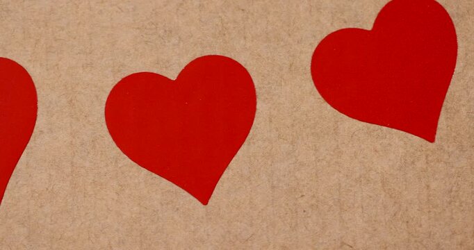 solid yellow cardboard for packaging goods and products with red plastic hearts , part of the corrugated cardboard packaging board with red hearts glued on