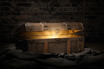 Vintage treasure chest in a dark dungeon opens to reveal a luminous but hidden secret