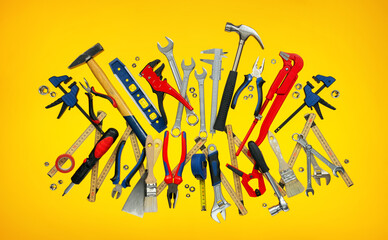 A set of many tools on eye-catching yellow background. Suitable to represent work, craftsmanship, handcraft, carpentry or home improvement. 