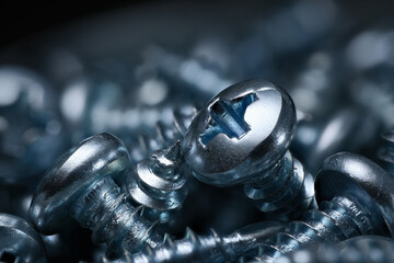 Screws macro studio shot in steel blue color. Extreme closeup of small objects.