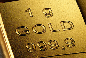 Extreme closeup of a 1 gram piece of pure gold. Finance concept for the high price at the gold market.