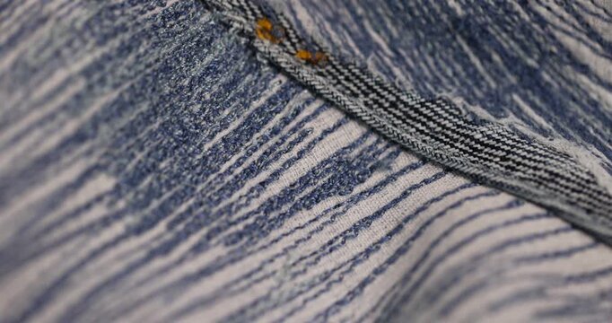 old blue repaired jeans after they are torn, patching with a lot of threads after repairing jeans with a lot of scuff
