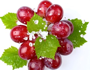 Fresh red grapes with green leaves and water droplets