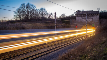 railway tunnel with light trails of a fast train